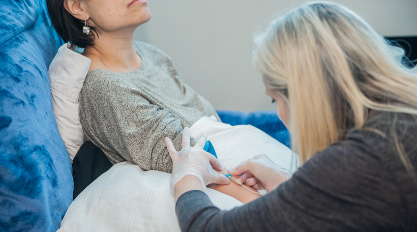 nurse injecting IV to the patient